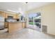 Bright kitchen featuring stainless steel appliances, granite countertops, light wood cabinetry and a view to the back patio at 7075 Welch Ct, Arvada, CO 80004