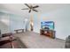Inviting living room with plush carpeting, a ceiling fan, and a TV with a scenic beach view at 7075 Welch Ct, Arvada, CO 80004