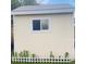 Exterior shot of the shed with a window and white picket fence at 7075 Welch Ct, Arvada, CO 80004