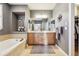 Bathroom features a dual sink vanity, large tub, tiled floors, and decorative accents at 2962 Akron Ct, Denver, CO 80238