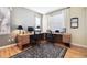 Well lit home office features a corner desk, with seating, and hardwood floors at 2962 Akron Ct, Denver, CO 80238