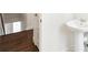 Bathroom with pedestal sink and wood look flooring at 5682 N Galena St, Denver, CO 80238