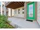 Front entrance featuring a green door, concrete slab, and an outdoor light at 5682 N Galena St, Denver, CO 80238