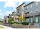 Modern townhomes with private balconies, green doors, and well-maintained landscaping and wooden fence at 5682 N Galena St, Denver, CO 80238