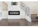 Contemporary fireplace with TV mount and modern staircase with metal railing at 5682 N Galena St, Denver, CO 80238