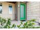 Close-up of the home's bright green front door and the address number at 5682 N Galena St, Denver, CO 80238