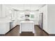 Bright, modern kitchen with white cabinets, stainless steel appliances, and a center island at 5682 N Galena St, Denver, CO 80238
