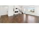 Bright living room boasts hardwood floors, fireplace, and staircase at 5682 N Galena St, Denver, CO 80238