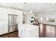 Living room open to kitchen with stainless steel appliances and white island at 5682 N Galena St, Denver, CO 80238