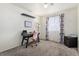 Bedroom featuring a desk, modern lamp, neutral carpet, and a window with floral curtains at 11083 Quail Ct, Parker, CO 80134