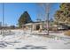 Charming clubhouse exterior with stone accents, covered porch, and well-maintained landscaping with visible snow cover at 11083 Quail Ct, Parker, CO 80134