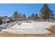 Winter view of the community pool area showcasing covered seating around the pool with mature trees in the background at 11083 Quail Ct, Parker, CO 80134