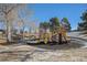 Bright and colorful community playground with slides, swings, and climbing structures, nestled among mature trees at 11083 Quail Ct, Parker, CO 80134