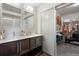 Bathroom with double vanity, modern fixtures, and sliding door to a walk-in closet at 17258 E 109Th Ave, Commerce City, CO 80022