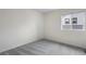 Empty bedroom with neutral carpet, white walls, and a window allowing natural light at 17258 E 109Th Ave, Commerce City, CO 80022