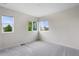 Bright bedroom with neutral carpet, white walls, and windows letting in natural light at 17258 E 109Th Ave, Commerce City, CO 80022