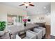 Bright dining room with an open floor plan to the kitchen, a modern table, and gray chairs at 17258 E 109Th Ave, Commerce City, CO 80022