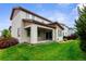 Backyard view showing the covered patio and grassy lawn of this two story home at 17258 E 109Th Ave, Commerce City, CO 80022