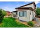 View of backyard and the covered patio attached to this two story home at 17258 E 109Th Ave, Commerce City, CO 80022