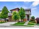 Stylish two-story home with a modern exterior, a well-maintained lawn, mature trees, and a welcoming entrance at 17258 E 109Th Ave, Commerce City, CO 80022