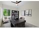 Bright home office with a window, desk, bookshelf, and two stylish chairs at 17258 E 109Th Ave, Commerce City, CO 80022