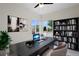 Bright home office with a window, desk, bookshelf, and two stylish chairs at 17258 E 109Th Ave, Commerce City, CO 80022
