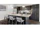 Spacious kitchen featuring a large island, stainless steel appliances, dark cabinets, granite countertops, and ample storage at 17258 E 109Th Ave, Commerce City, CO 80022