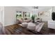 Bright and airy living room with neutral furniture, stylish décor, a view of the backyard, and hardwood flooring at 17258 E 109Th Ave, Commerce City, CO 80022