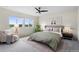 Cozy primary bedroom features a ceiling fan, a window view, and minimalist decor at 17258 E 109Th Ave, Commerce City, CO 80022