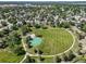 An aerial view of a park with a walking path, play structure, and green sport court at 18159 E Crestline Cir, Centennial, CO 80015