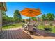 A backyard featuring a deck with an umbrella and outdoor seating at 18159 E Crestline Cir, Centennial, CO 80015