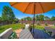 Backyard featuring a deck with an umbrella and plenty of space at 18159 E Crestline Cir, Centennial, CO 80015