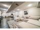 Spacious basement featuring a sectional couch, modern decor, and a treadmill at 18159 E Crestline Cir, Centennial, CO 80015