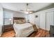 Comfortable bedroom featuring hardwood floors, a ceiling fan, and closet space at 18159 E Crestline Cir, Centennial, CO 80015