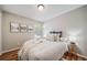 Comfortable bedroom with decorative artwork, a plush bed, and a sunlit window at 18159 E Crestline Cir, Centennial, CO 80015
