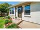 Charming home entrance with brick accents, mature landscaping, and covered front entry at 18159 E Crestline Cir, Centennial, CO 80015
