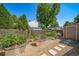 Backyard garden featuring raised galvanized steel planters with gravel ground cover and a small storage shed at 18159 E Crestline Cir, Centennial, CO 80015