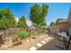 Backyard garden featuring raised galvanized steel planters with gravel ground cover and concrete paver walkway at 18159 E Crestline Cir, Centennial, CO 80015