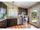 Well-lit kitchen with stainless steel appliances, granite countertops and dark wood cabinetry at 18159 E Crestline Cir, Centennial, CO 80015