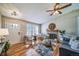 Inviting living room with a fireplace, hardwood floors, and a ceiling fan at 18159 E Crestline Cir, Centennial, CO 80015