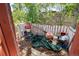 View of back porch filled with assorted discarded items and overgrown trees behind at 2410 W 36Th Ave, Denver, CO 80211