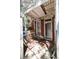 View of back porch with deteriorated walls, trash and a metal security door at 2410 W 36Th Ave, Denver, CO 80211