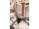 View of basement access with deteriorated brick walls, broken boards, and accumulated trash at 2410 W 36Th Ave, Denver, CO 80211