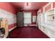 This bedroom features red carpet, shelving, and a window covered by a white curtain, creating a cozy yet fixer-upper feel at 2410 W 36Th Ave, Denver, CO 80211
