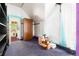 Attic bedroom with purple carpet, white walls, vintage wardrobe, and colorful trim detail at 2410 W 36Th Ave, Denver, CO 80211
