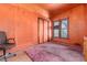 Orange bedroom features a closet, window with blinds, and a vintage chair at 2410 W 36Th Ave, Denver, CO 80211