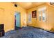 Bedroom featuring yellow walls, blue carpet, doors to other rooms, and vintage posters at 2410 W 36Th Ave, Denver, CO 80211