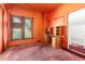 Orange bedroom featuring a built-in desk, and window with blinds providing natural light at 2410 W 36Th Ave, Denver, CO 80211