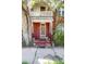Exterior view of a brick two-story home, featuring a charming front porch shaded by trees at 2410 W 36Th Ave, Denver, CO 80211