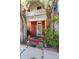 A charming red brick two-story home featuring a cozy front porch and mature trees at 2410 W 36Th Ave, Denver, CO 80211